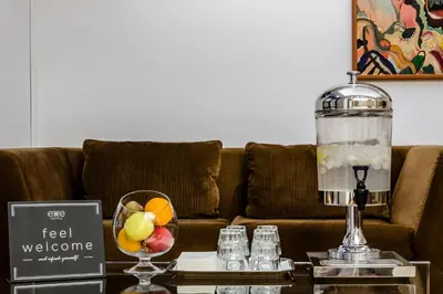 a coffee table with a fruit bowl and a blender at Exe Domus Aurea in Rome