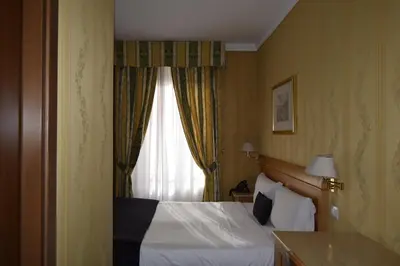 two beds in a room with yellow covers on them at Hotel dei Quiriti in Rome