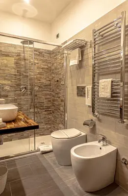 a bathroom with a toilet and a sink and a shower at Hotel Miami in Rome