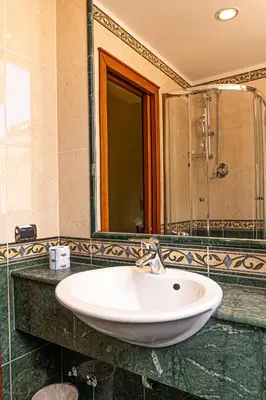 a bathroom with a white sink and a mirror at Hotel Miami in Rome