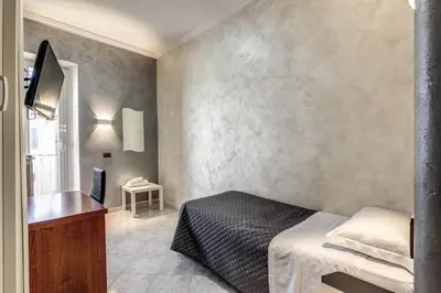 a bedroom with a bed and a television in it at Hotel Planet in Rome