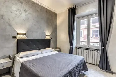 a bedroom with a large bed and a window at Hotel Planet in Rome