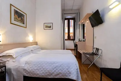 a hotel room with a bed and a flat screen tv at Hotel Julia Trevi - Spagna in Rome