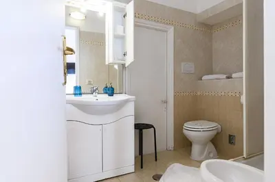 a bathroom with a white sink and a toilet at Hotel Julia Trevi - Spagna in Rome