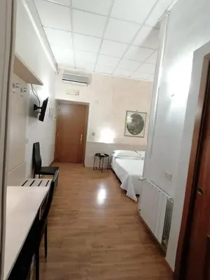 a hospital room with two beds and a hallway at Hotel Julia Trevi - Spagna in Rome