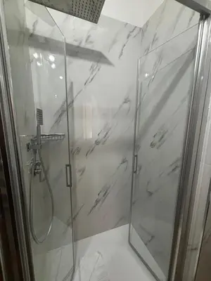 a bathroom with a shower with a glass door at Hotel Gabriella in Rome