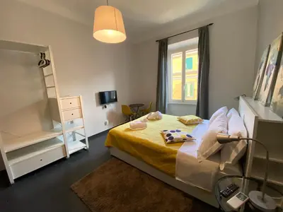 a small bedroom with a bed and a window at Guest House Rome by GHOR in Rome
