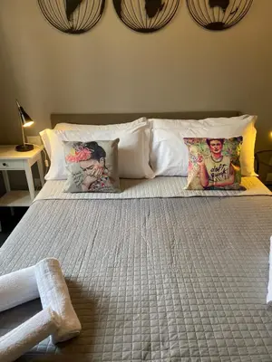 a bedroom with a bed with pillows on it at Guest House Rome by GHOR in Rome