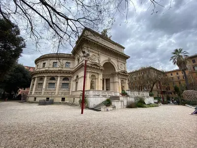 a large stone building with a palm tree in front of it at Guest House Rome by GHOR in Rome