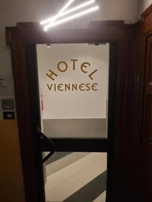 a sign on a door with a hotel sign on it at Hotel Viennese in Rome