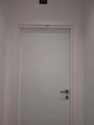 a white garage door in a white room at Hotel Viennese in Rome