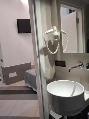 a bathroom with a sink and a mirror at Hotel Viennese in Rome