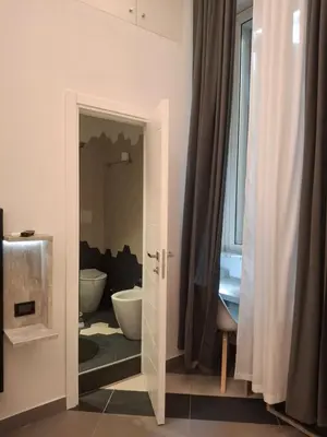 a bathroom with a tub and a toilet in a room at Hotel Viennese in Rome