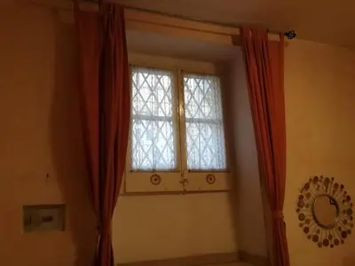 a window in a room with red curtains at Casa Zavatti in Rome