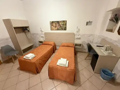 a room with two beds and a sink at Casa Zavatti in Rome