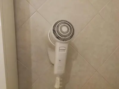 a white fan in a corner of a bathroom at Casa Zavatti in Rome