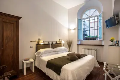 a bedroom with a large bed with a window at B&B Arco Del Lauro in Rome