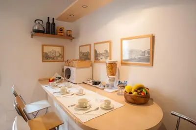 a kitchen with a table with a bowl of fruit on it at Sotto La Cupola in Rome