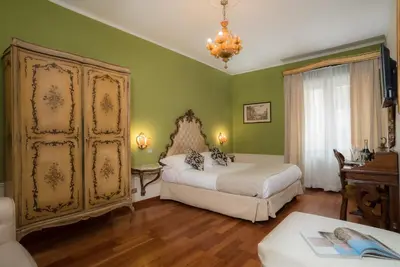 a bedroom with two beds and green walls at Sotto La Cupola in Rome