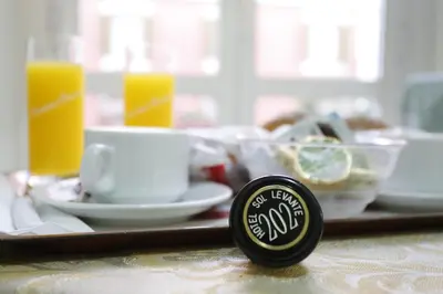 a table with a tray of food and a cup of coffee at Hotel Sol Levante in Rome
