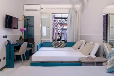 a living room with a couch and a table at Hotel Grifo in Rome