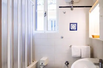 a bathroom with a sink and a window at Hotel Grifo in Rome