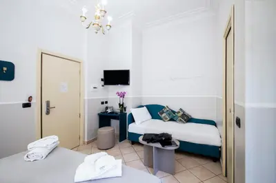 a hotel room with two beds and a mirror at Hotel Grifo in Rome