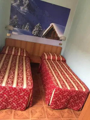 two beds in a room with a painting on the wall at Hotel Gabriele in Rome