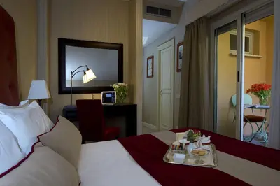 a hotel room with a bed with a tray of food on it at Hotel dei Borgognoni in Rome