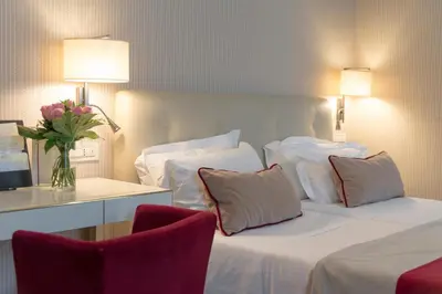 a hotel room with a bed and a table and chairs at Hotel dei Borgognoni in Rome