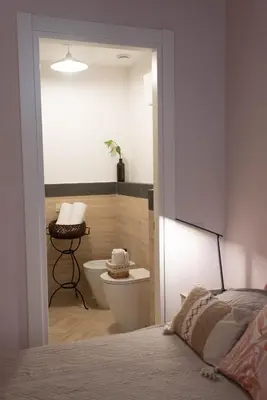a bedroom with a bathroom with a toilet and a bed at Boutique Grifone in Rome