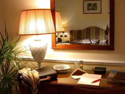 a lamp sitting on a desk in a hotel room at Hotel Cellini in Rome