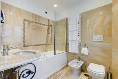 a bathroom with a sink and a toilet at Hotel Cellini in Rome
