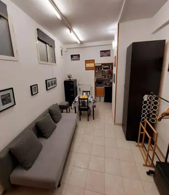 a living room with a couch and a table at Mini Suite Indipendente in Rome