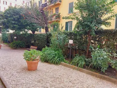 a garden with potted plants in front of a building at Mini Suite Indipendente in Rome