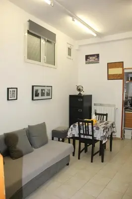 a living room with a couch and a table at Mini Suite Indipendente in Rome