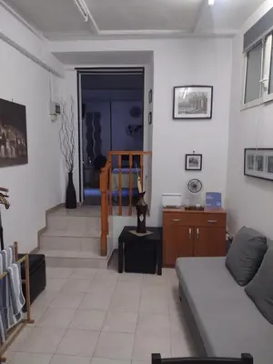 a living room with a couch and a staircase at Mini Suite Indipendente in Rome