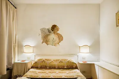 a bedroom with a angel painting on the wall at Palazzo Donarelli in Rome