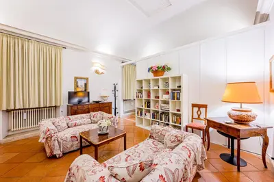 a living room with two couches and a tv at Palazzo Donarelli in Rome