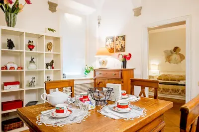 a dining room with a table with cups and plates on it at Palazzo Donarelli in Rome