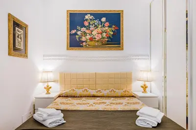 a bedroom with a bed with a painting on the wall at Palazzo Donarelli in Rome