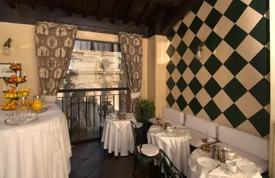 a living room with a couch and a painting on the wall at Hotel Fontana in Rome