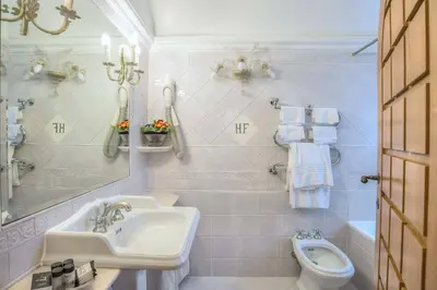 a white bathroom with a sink and a toilet at Hotel Fontana in Rome