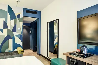 a room with a tv and a couch and a bed at Belstay Roma Aurelia in Rome