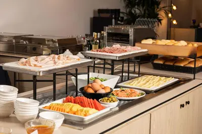 a buffet with several trays of different types of food at Belstay Roma Aurelia in Rome