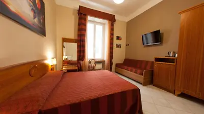 a hotel room with a bed and a couch at Dama Private Rooms in Rome