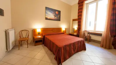 a bedroom with a red bed and a window at Dama Private Rooms in Rome