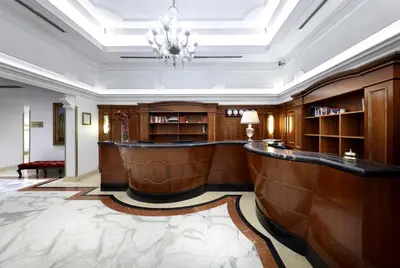 a large lobby with a bar in a building at Exe International Palace in Rome
