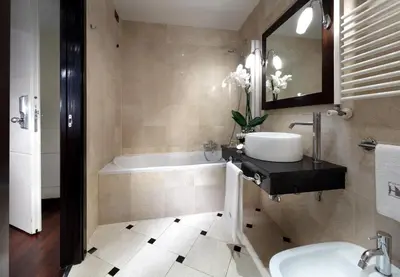 a bathroom with a sink and a bath tub at Exe International Palace in Rome