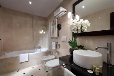 a bathroom with a sink and a toilet and a tub at Exe International Palace in Rome